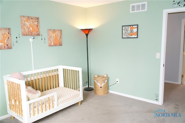 bedroom featuring carpet flooring and a nursery area