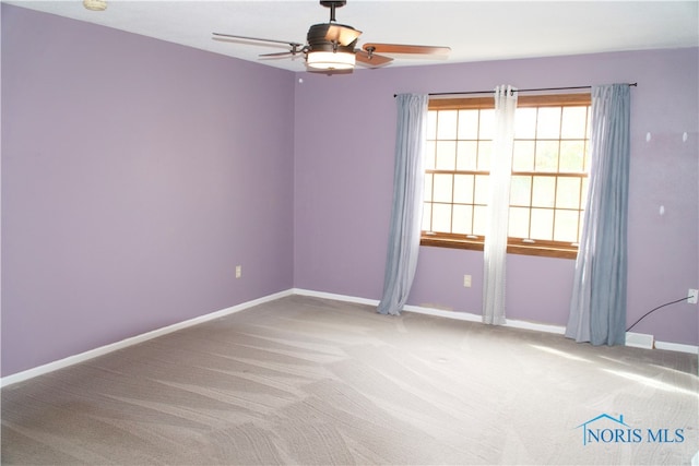 empty room featuring carpet floors and ceiling fan