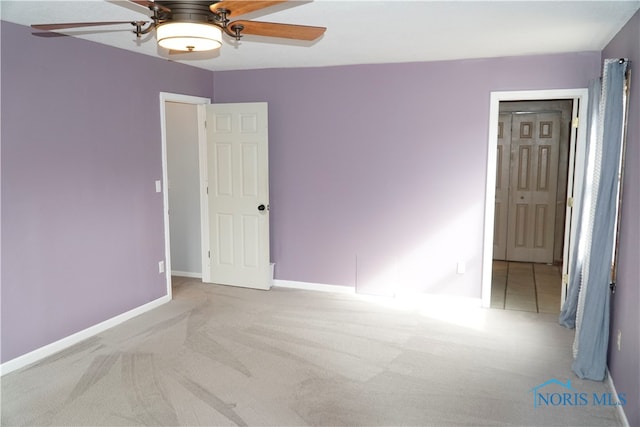 carpeted empty room with ceiling fan