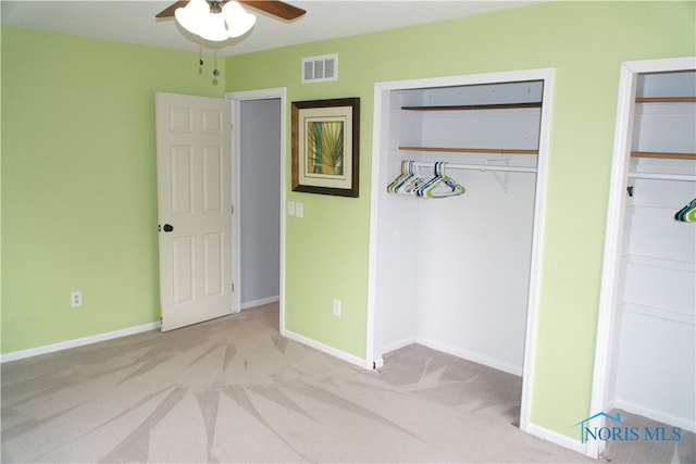 unfurnished bedroom featuring a closet, light carpet, and ceiling fan