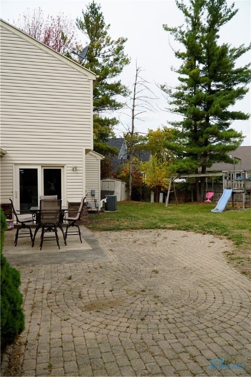 view of patio featuring cooling unit and a playground