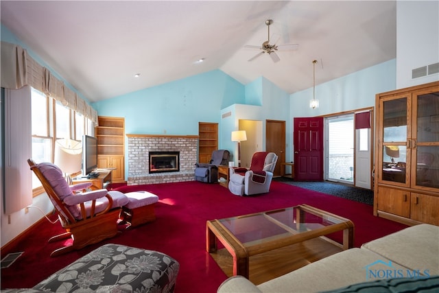 carpeted living room with ceiling fan, high vaulted ceiling, a wealth of natural light, and a brick fireplace