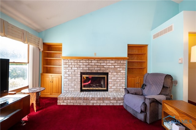 living room featuring carpet, lofted ceiling, and a fireplace