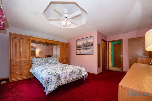 carpeted bedroom with a textured ceiling and ceiling fan