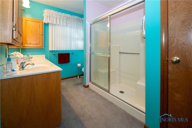 bathroom with vanity, an enclosed shower, and toilet