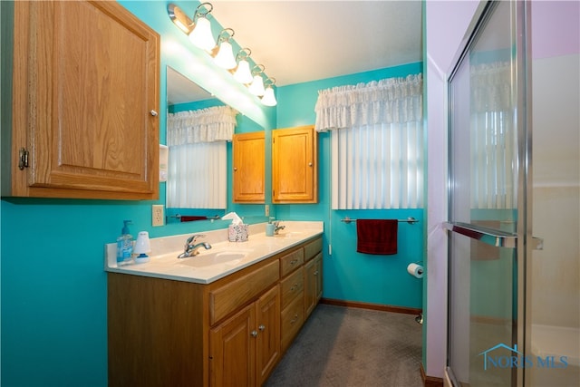 bathroom featuring vanity and a shower with door