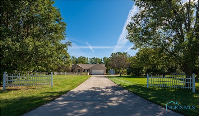 view of front of property featuring a front lawn and a garage