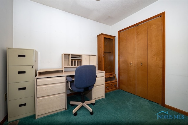 unfurnished office featuring dark carpet