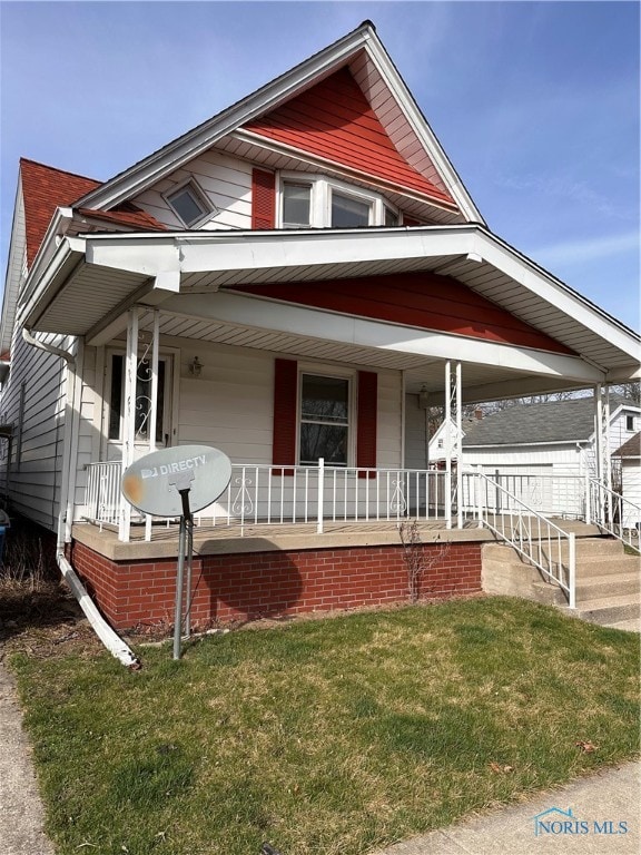 view of front of house featuring a front yard and a porch