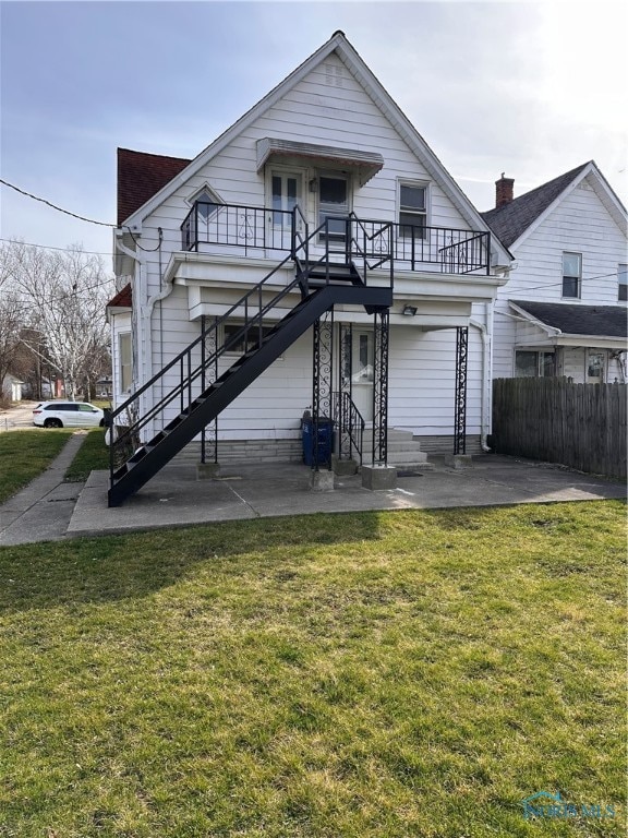 rear view of property with a lawn