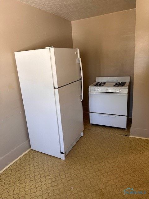 kitchen with white appliances and a textured ceiling