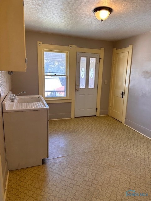 interior space with sink and a textured ceiling