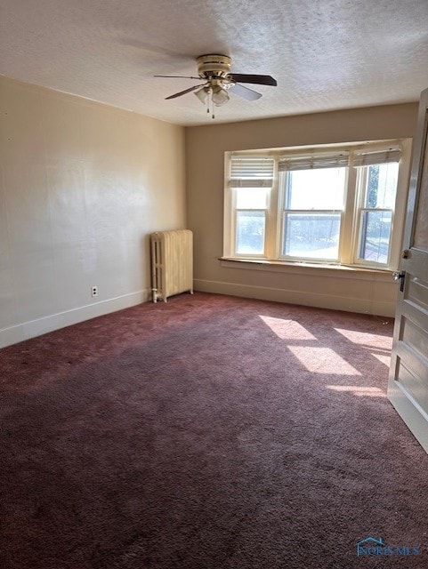 unfurnished room featuring a textured ceiling, ceiling fan, radiator heating unit, and carpet flooring