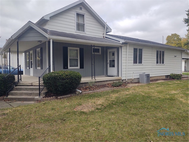 view of front of house featuring a front lawn, central AC, and covered porch