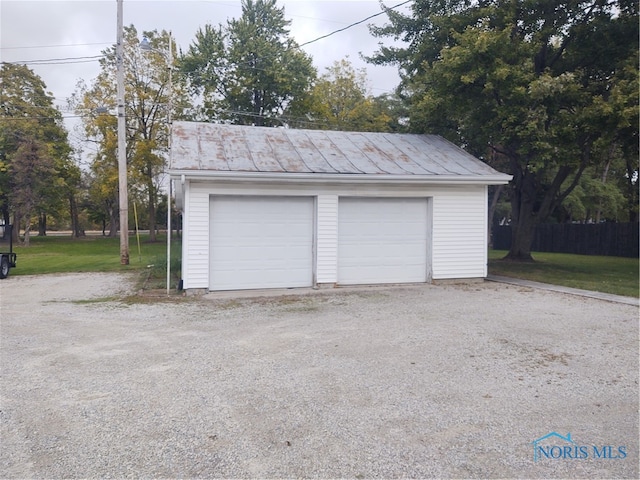 garage featuring a lawn