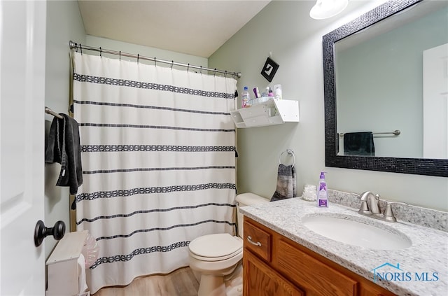 bathroom featuring a shower with curtain, vanity, and toilet