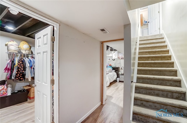 staircase featuring wood-type flooring