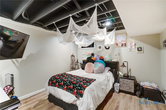 bedroom with hardwood / wood-style floors