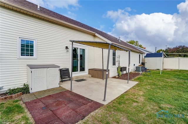 rear view of property with a yard and a patio area