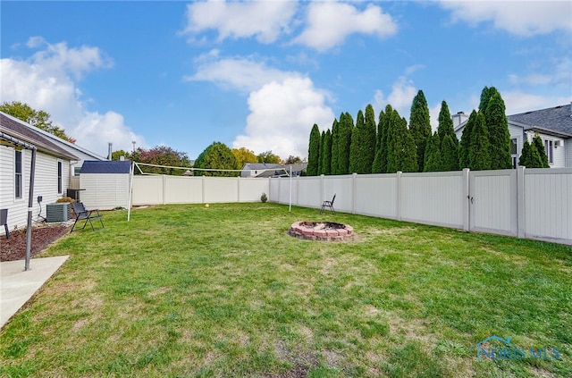 view of yard with an outdoor fire pit and cooling unit