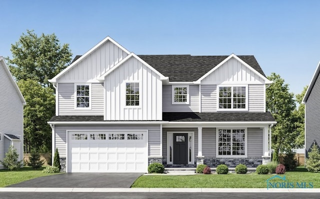 view of front of property with a garage and a front lawn