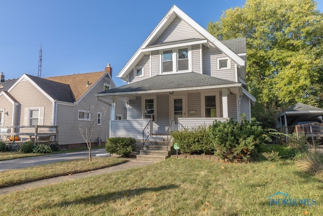 view of front of property featuring covered porch and a front yard