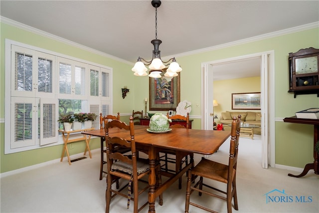 carpeted dining space with ornamental molding and a notable chandelier