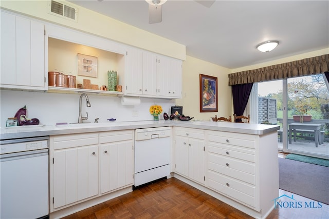 kitchen featuring white dishwasher, dark parquet floors, white cabinetry, and kitchen peninsula