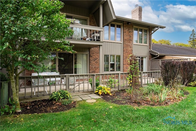 rear view of property with a balcony