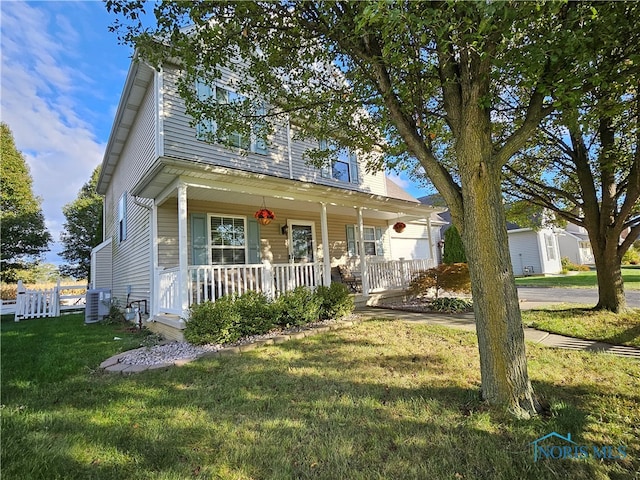 view of front of property with a porch, a front lawn, and central AC