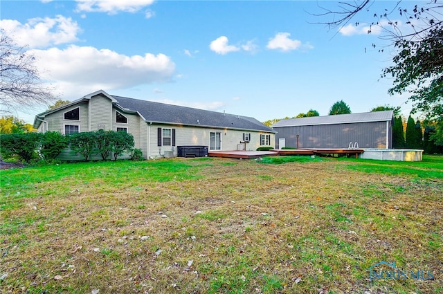 rear view of property with a deck and a lawn