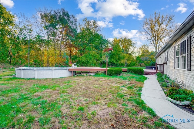 view of yard with a pool side deck