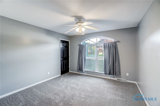 spare room with carpet floors and ceiling fan