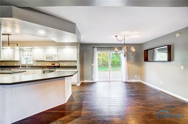 kitchen featuring decorative light fixtures, an inviting chandelier, electric stove, white cabinetry, and dark hardwood / wood-style flooring