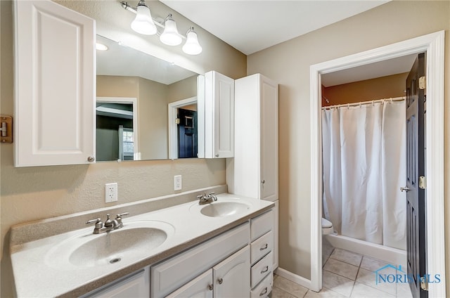 bathroom with walk in shower, vanity, toilet, and tile patterned floors