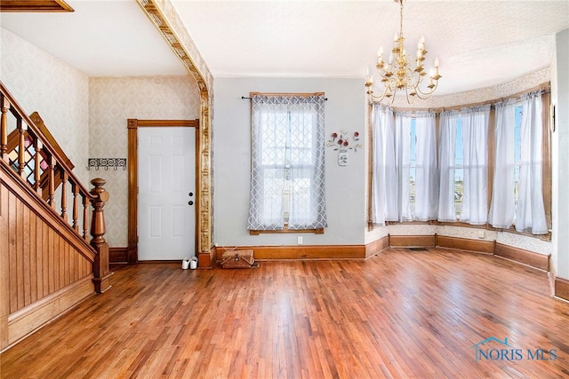 entryway featuring hardwood / wood-style floors and a notable chandelier