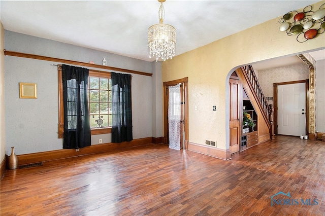 foyer featuring an inviting chandelier and hardwood / wood-style flooring