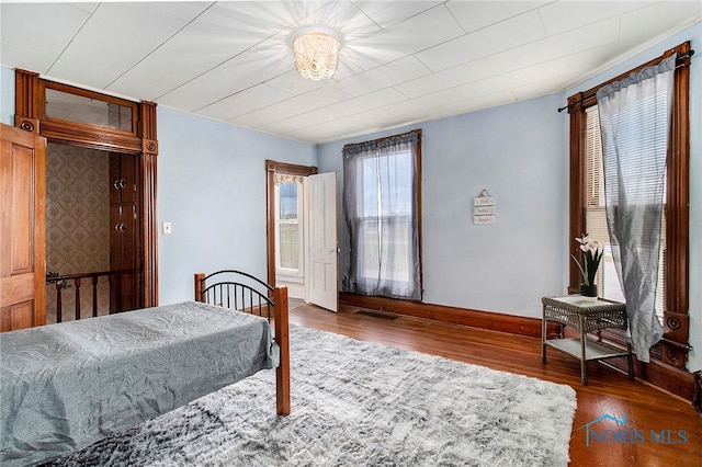 bedroom with dark wood-type flooring