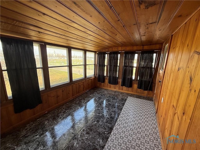 unfurnished sunroom featuring lofted ceiling and wood ceiling