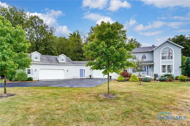 view of front of property featuring a front yard and a garage