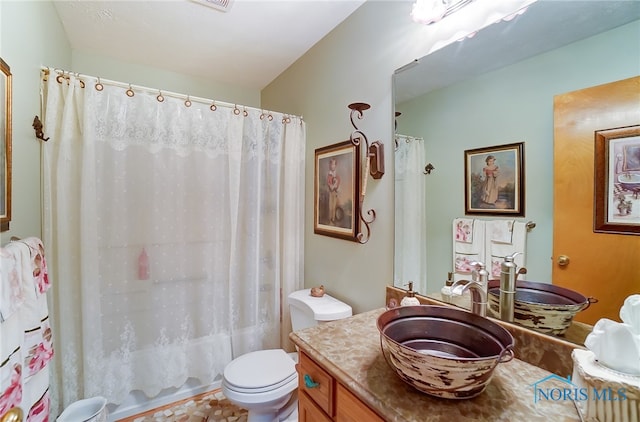 bathroom featuring vanity, toilet, and a shower with shower curtain