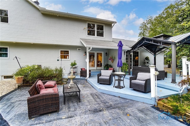 rear view of property featuring a gazebo, a patio area, and outdoor lounge area