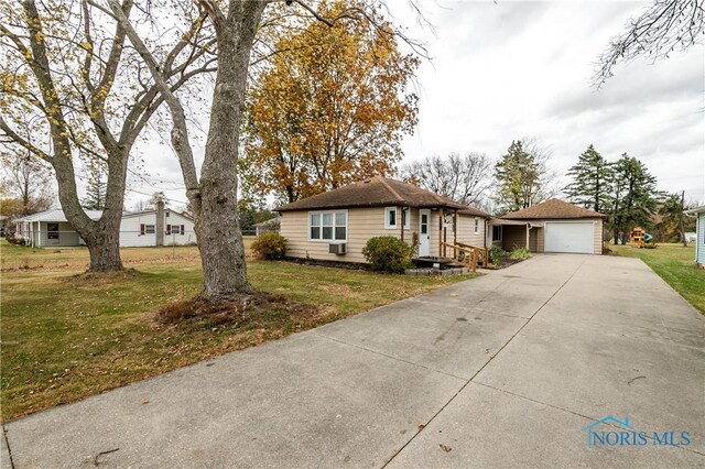 view of front of property with a front yard and a garage