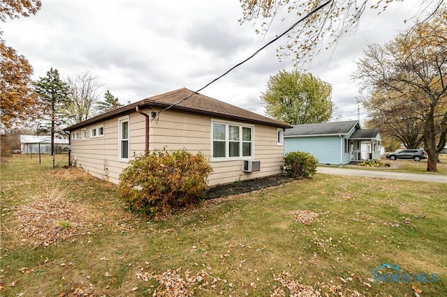 view of side of home featuring a lawn