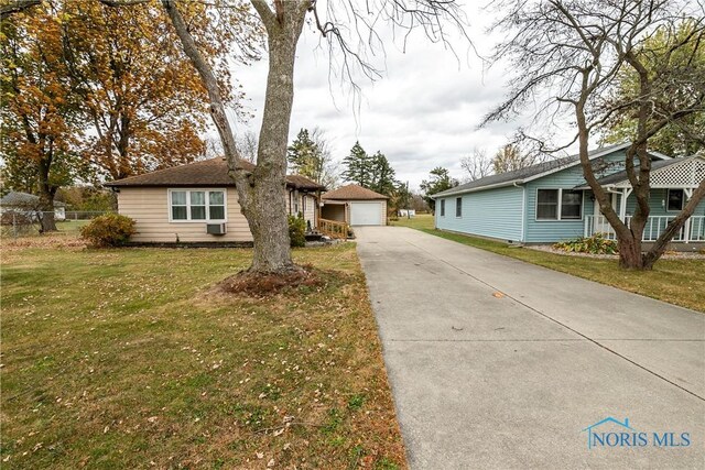 single story home with a front yard and a garage