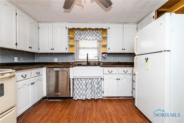 kitchen with white cabinets, a textured ceiling, dark wood-type flooring, and white appliances