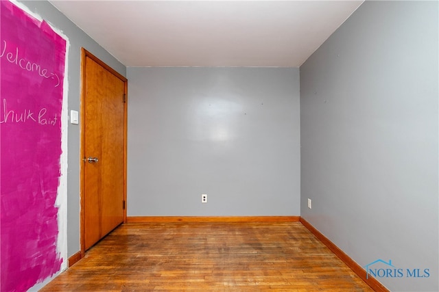 empty room featuring wood-type flooring