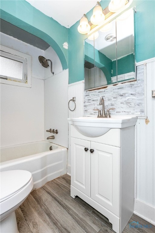 full bathroom with vanity, toilet, wood-type flooring, and shower / bathtub combination