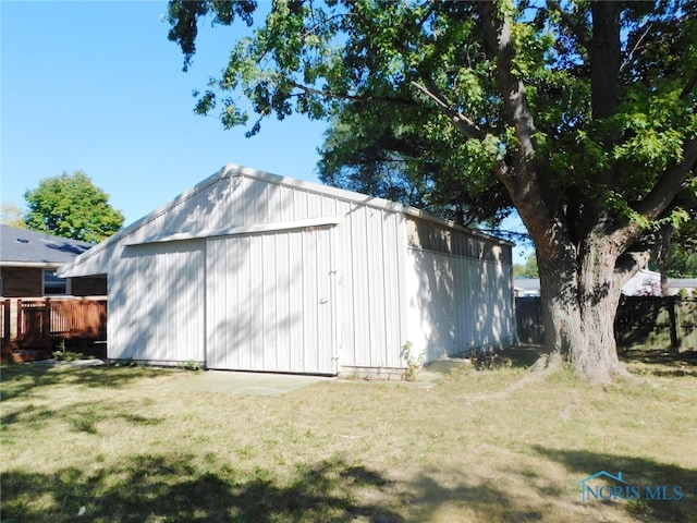 view of outbuilding with a yard