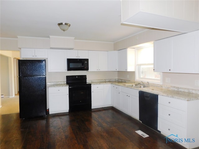 kitchen featuring dark hardwood / wood-style flooring, white cabinetry, ornamental molding, black appliances, and sink